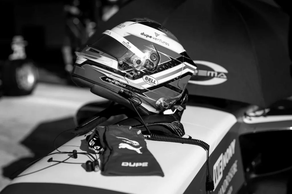 Racing helmet resting on the car.