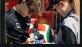 A driver signing for a fan.