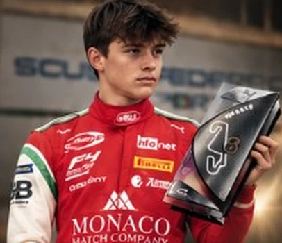 Andrea Dupé in a red suit with a trophy.