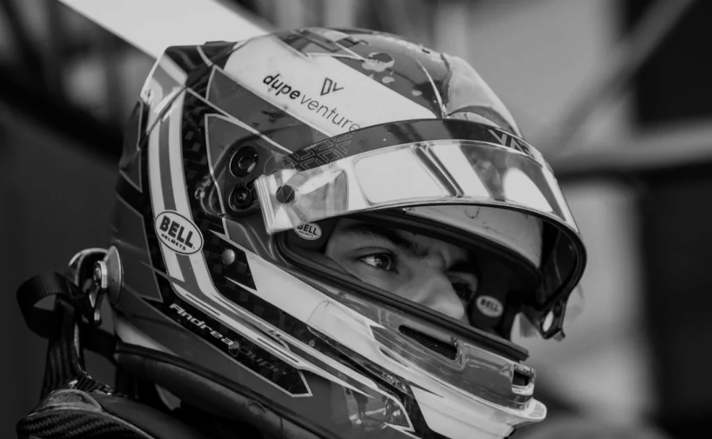 Close-up of a racing driver in a Bell helmet.
